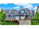 Stunning two-story home boasts a blue exterior, brick accents, and a well-manicured front yard at 20010 Prescott Pl, Westfield, IN 46074