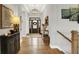 Bright foyer features hardwood flooring, elegant lighting, and a view of the decorative front door at 20010 Prescott Pl, Westfield, IN 46074