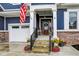 Inviting entryway features a decorative front door, beautiful landscaping, and an American flag at 20010 Prescott Pl, Westfield, IN 46074