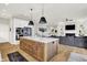 Open concept kitchen and living room area, with large island, stainless appliances, and hardwood flooring at 20010 Prescott Pl, Westfield, IN 46074