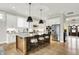 Modern kitchen featuring a spacious island, stainless steel appliances, and hardwood floors at 20010 Prescott Pl, Westfield, IN 46074