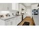 Modern kitchen featuring white cabinets, subway tile backsplash, stainless steel appliances, and hardwood floors at 20010 Prescott Pl, Westfield, IN 46074