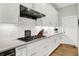 Bright kitchen featuring white cabinets, a modern stainless steel range hood, and subway tile backsplash at 20010 Prescott Pl, Westfield, IN 46074