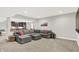 Comfortable living area in basement, complete with gray sectional sofa and open floor plan at 20010 Prescott Pl, Westfield, IN 46074