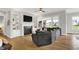 Cozy living room with a fireplace, built-in bookshelves, and hardwood floors at 20010 Prescott Pl, Westfield, IN 46074