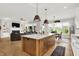 Open-concept living space with a fireplace, built-in shelves, and a view of the backyard at 20010 Prescott Pl, Westfield, IN 46074