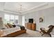 Comfortable main bedroom features a tray ceiling, large windows, and stylish decor at 20010 Prescott Pl, Westfield, IN 46074