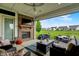 Covered patio with brick fireplace, comfortable seating, and a view of the expansive backyard at 20010 Prescott Pl, Westfield, IN 46074
