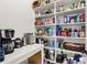 Well-organized walk-in pantry featuring ample shelving space for storing groceries and kitchen appliances at 20010 Prescott Pl, Westfield, IN 46074