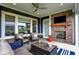 Comfortable covered patio with a brick fireplace and mounted television for outdoor enjoyment at 20010 Prescott Pl, Westfield, IN 46074
