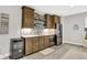Basement wet bar with custom cabinets, stainless steel appliances, and beverage cooler at 20010 Prescott Pl, Westfield, IN 46074