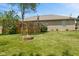Large grassy backyard with a stone fire pit and a multi-level deck at 205 Canaan Ct, Mooresville, IN 46158