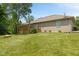 Backyard view with a large lawn, a fire pit, and an upper level deck at 205 Canaan Ct, Mooresville, IN 46158