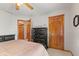 Bedroom with tan carpet, natural trim, black dresser, and doorway to another room at 205 Canaan Ct, Mooresville, IN 46158
