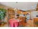 Bright dining area adjacent to kitchen, featuring wood floors and natural light at 205 Canaan Ct, Mooresville, IN 46158