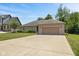 Well-manicured lawn, landscaping, and a concrete driveway leading to the two-car garage at 205 Canaan Ct, Mooresville, IN 46158