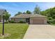 Charming ranch home featuring a well-maintained lawn, landscaping, and a two-car garage at 205 Canaan Ct, Mooresville, IN 46158