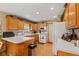 Bright kitchen with wooden cabinets, white appliances, and updated countertops offers an inviting space at 205 Canaan Ct, Mooresville, IN 46158