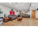Finished basement with hardwood flooring, two leather sofas, stairs, and wooden doors at 205 Canaan Ct, Mooresville, IN 46158