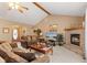 Cozy living room features a brick fireplace, vaulted ceiling, and comfortable seating at 205 Canaan Ct, Mooresville, IN 46158