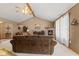 Spacious living room featuring a fireplace, a ceiling fan, and an open layout at 205 Canaan Ct, Mooresville, IN 46158