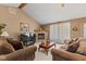 Comfortable living room with a fireplace, and large windows with backyard views at 205 Canaan Ct, Mooresville, IN 46158