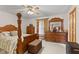 Comfortable bedroom featuring a four-poster bed, matching dressers, and a ceiling fan at 205 Canaan Ct, Mooresville, IN 46158