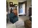 Inviting living room showcasing a cozy blue chair, hardwood floors and a bright entrance with a blue door at 21749 Oak Ridge Rd, Sheridan, IN 46069