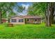 Inviting backyard with outdoor seating area and verdant lawn, ideal for relaxation and entertainment at 2228 Dover St, Anderson, IN 46013