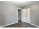 Bright bedroom with gray walls, wood floors, and closet, offering a serene atmosphere at 2228 Dover St, Anderson, IN 46013