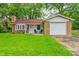 Charming brick home with a well-maintained lawn, brick chimney, and attached one car garage at 2228 Dover St, Anderson, IN 46013