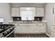 Kitchen featuring white cabinets, modern backsplash, and stainless steel appliances at 2228 Dover St, Anderson, IN 46013