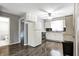 Bright kitchen featuring white cabinets, stainless steel appliances, and wood-look flooring at 2228 Dover St, Anderson, IN 46013