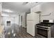 Open-concept kitchen and living area with stainless steel appliances and a cozy fireplace at 2228 Dover St, Anderson, IN 46013