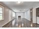 Large living room with gray walls, ceiling fan, wood floors and a decorative fireplace with white mantle at 2228 Dover St, Anderson, IN 46013