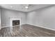 Living room with gray walls, ceiling fan, wood floors and a decorative fireplace with white mantle at 2228 Dover St, Anderson, IN 46013