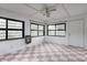Bright sun room with large windows, tile floor, and a ceiling fan at 2228 Dover St, Anderson, IN 46013