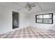 Bright sun room featuring tile flooring, ceiling fan and exterior access at 2228 Dover St, Anderson, IN 46013