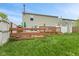 Exterior home view featuring a wooden deck and a lawn under a bright blue sky at 2249 Blossom Dr, Greenwood, IN 46143