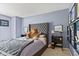Comfortable bedroom features a queen bed with upholstered headboard, a teddy bear, and a side table with decorations at 2249 Blossom Dr, Greenwood, IN 46143