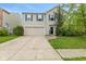 Charming two-story home with a well-maintained lawn, two-car garage and beautiful blue shutters at 2249 Blossom Dr, Greenwood, IN 46143