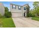 Charming two-story home with a well-maintained lawn, two-car garage and beautiful blue shutters at 2249 Blossom Dr, Greenwood, IN 46143