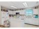 Bright kitchen featuring white cabinets, modern appliances, an island and natural light at 2249 Blossom Dr, Greenwood, IN 46143