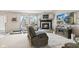 Spacious living room with a cozy fireplace, comfortable seating, and a large screen television at 2249 Blossom Dr, Greenwood, IN 46143