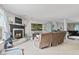 Spacious living room with a cozy fireplace, comfortable seating, and views into another room at 2249 Blossom Dr, Greenwood, IN 46143