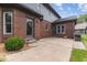 View of brick and siding exterior with a paved back patio and landscaped yard at 248 Runyon Ct, Greenwood, IN 46142