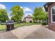 View of backyard with a grill, manicured lawn and lush trees at 248 Runyon Ct, Greenwood, IN 46142