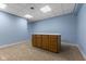 Finished basement includes neutral carpet, a drop ceiling, and a built in table with wood cabinets at 248 Runyon Ct, Greenwood, IN 46142