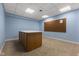 Finished basement with neutral carpet, drop ceiling, and a work table along with a peg board on the wall at 248 Runyon Ct, Greenwood, IN 46142