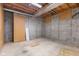 Unfinished basement with concrete floor and exposed wood ceiling structure and support beam at 248 Runyon Ct, Greenwood, IN 46142